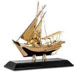 Golden metal yacth model with wooden base as dubai souvenir or traditional gifts wholesale supplier in dubai