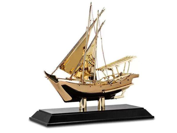 Golden metal yacth model with wooden base as dubai souvenir or traditional gifts wholesale supplier in dubai