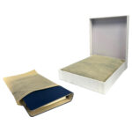 Closed and open white book boxes with covers.