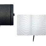 Closed and open black notebook with lined pages.