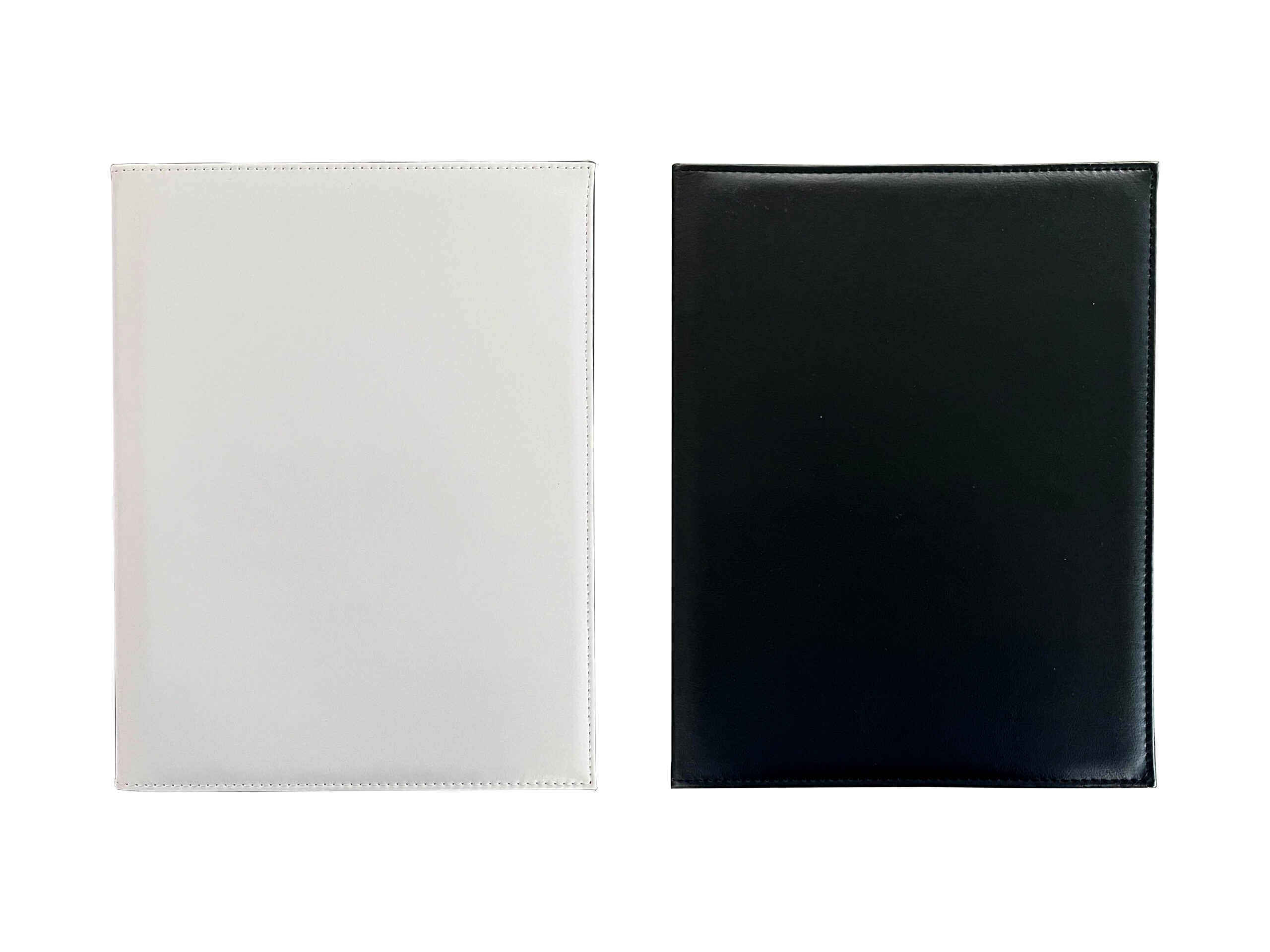 White and black leathern notebooks side by side