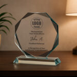 Glass award on table with lamp and plant