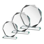 Three octagonal glass awards on stands
