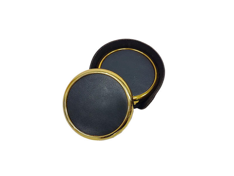 Black and gold round leather box on white background.
