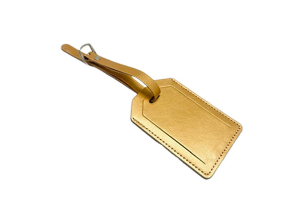 Golden luggage tag on white background.