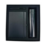 Black pen, notebook, and tumbler gift set.