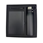 Gift set with notebook, pen, and bottle.