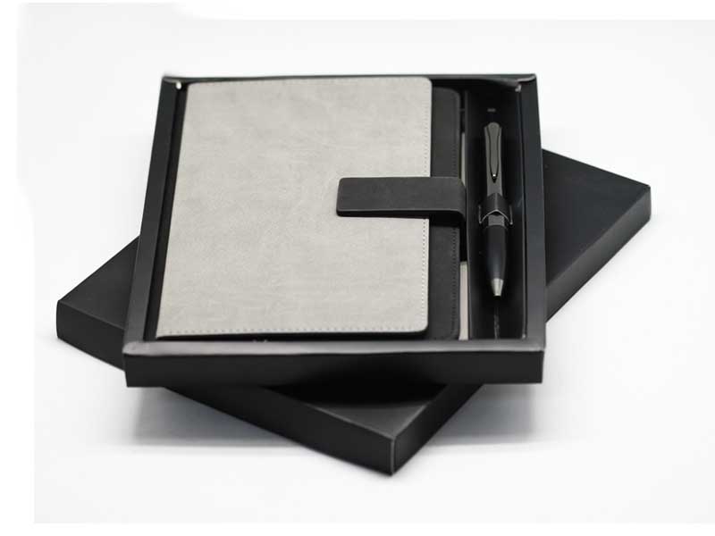 Gray leather notebook and pen in gift box.