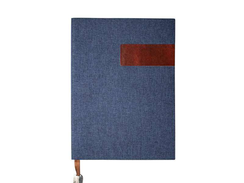 Blue textured notebook with brown leather accent