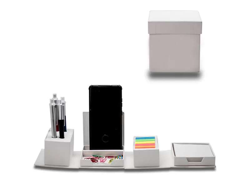 Organized desk set with smartphone, pens, sticky notes.