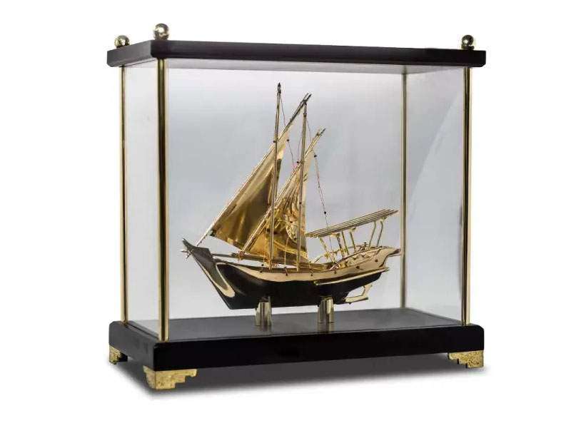 Gold ship model in glass display case