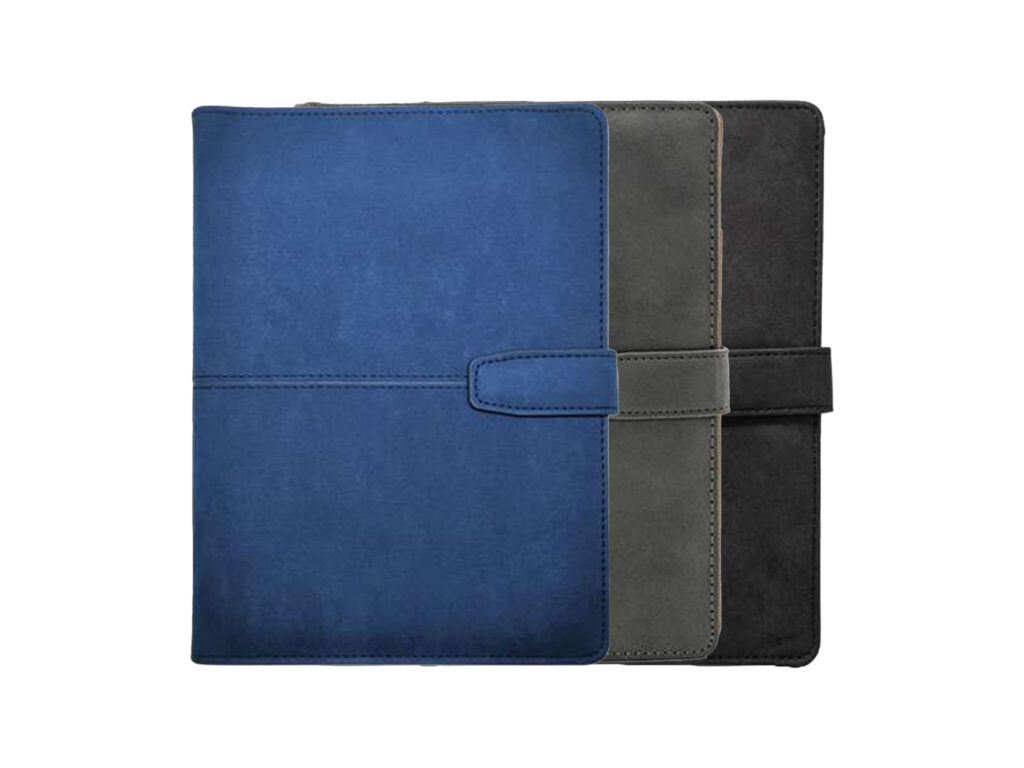 Stack of three leather journals in different colors.