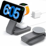 Multidevice charging station with phone, watch, and earphones.