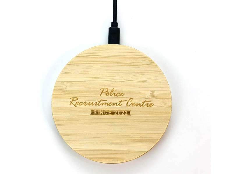 Bamboo wireless charger with engraved text.