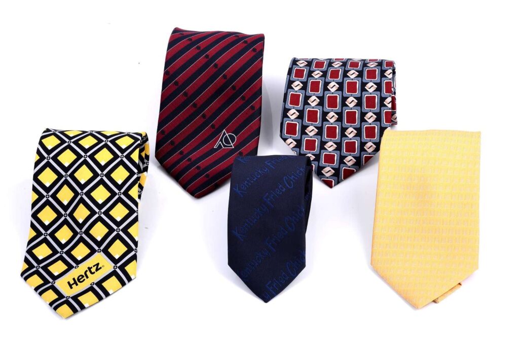 Five patterned neckties in various colors.
