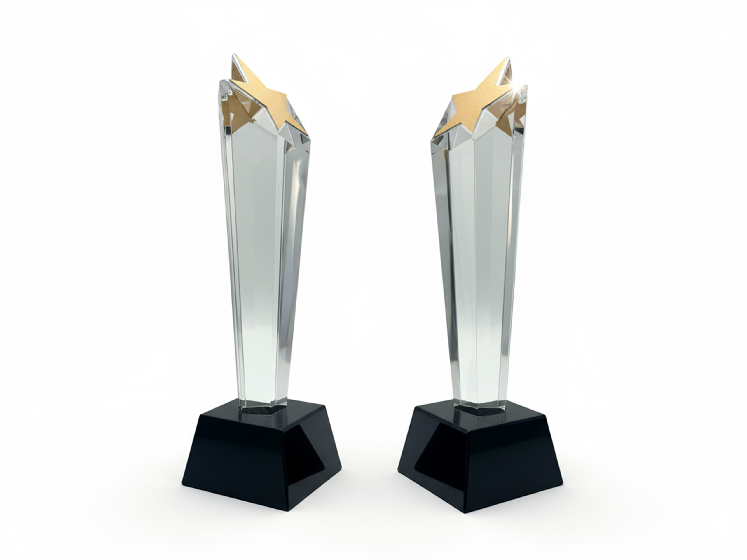 Two star-topped glass trophies on black bases.
